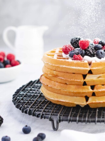 Stack of buttermilk belgian waffles with berries