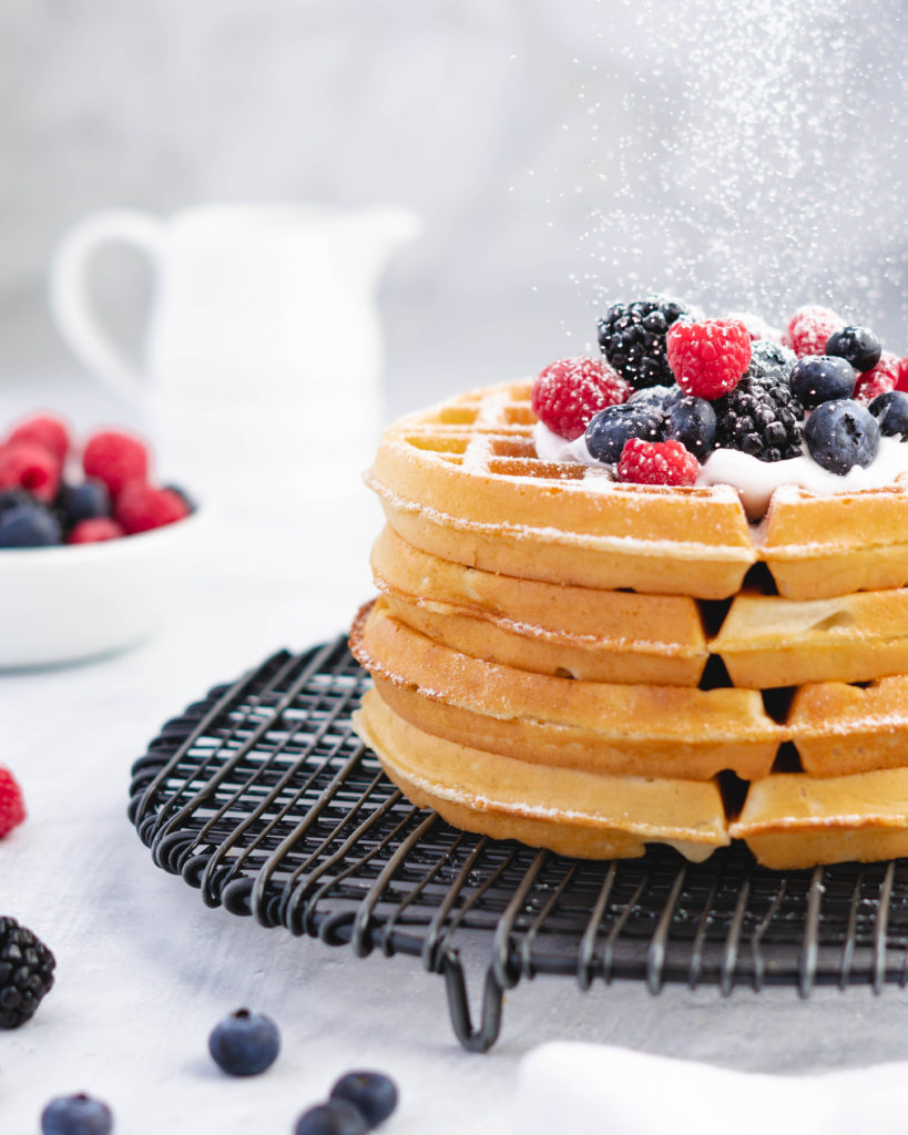 Stack of buttermilk belgian waffles with berries
