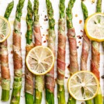 Crispy prosciutto wrapped around fresh green asparagus fresh from the oven
