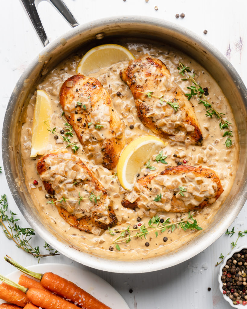 Chicken in pan, topped with white wine cream sauce