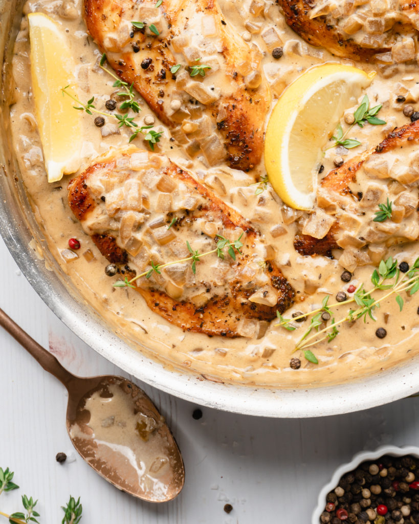 Chicken in pan, topped with white wine cream sauce