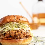 chicken is added to the slow cooker with honey bourbon bbq sauce, to make sweet, smoky, tender bbq chicken sandwiches