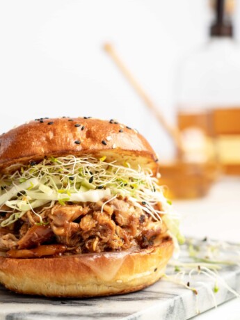 chicken is added to the slow cooker with honey bourbon bbq sauce, to make sweet, smoky, tender bbq chicken sandwiches