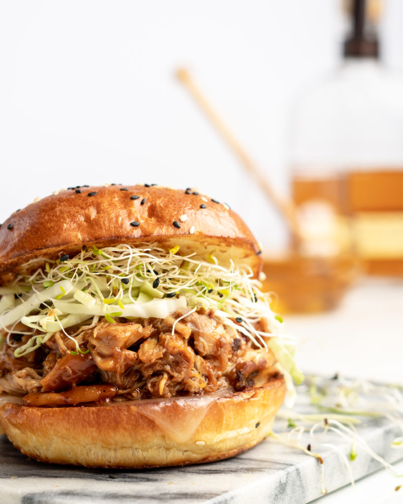 chicken is added to the slow cooker with honey bourbon bbq sauce, to make sweet, smoky, tender bbq chicken sandwiches