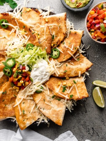 Super crispy quesadillas filled with tropical pineapple lime chicken, monterrey jack cheese, corn, black beans, and peppers