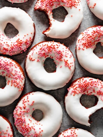 Easy to make baked red velvet donuts are glazed with a cream cheese frosting