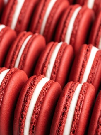 Red Velvet Macarons, filled with cream cheese frosting, lined up ready to be eaten