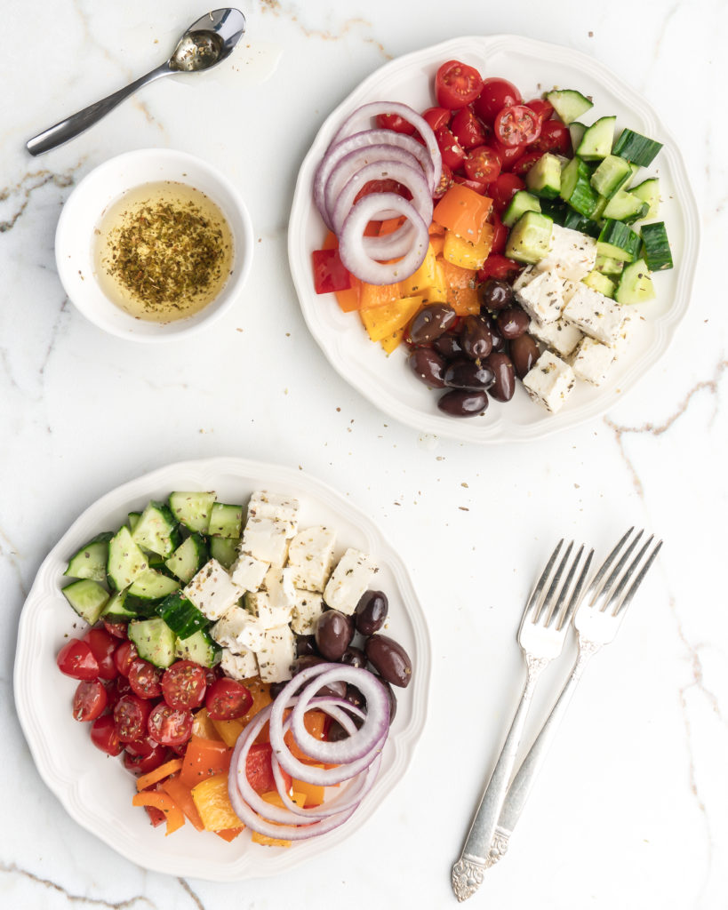 This easy greek salad features peppers, cucumbers, cherry tomatoes, Kalamata olives, feta cheese, red onions, and a homemade dressing