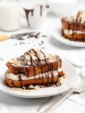 Fluffy Tiramisu flavored French Toast is topped with a delicious dollop of mascarpone whip cream, then drizzled with dark chocolate ganache