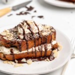 Fluffy Tiramisu flavored French Toast is topped with a delicious dollop of mascarpone whip cream, then drizzled with dark chocolate ganache