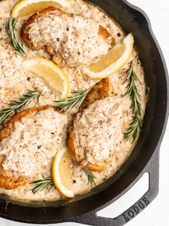 A delicious pan sauce is made after searing chicken breasts, with white wine, onions, shallots, rosemary, cream, mustard, and maple syrup.