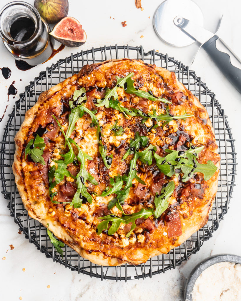 Prosciutto, goat cheese, and balsamic reduction are added to your typical pizza, and then baked in a cast iron pan to create a pizzeria style pizza at home!