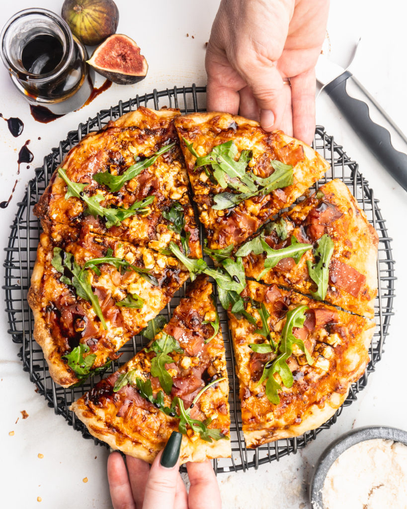 Prosciutto, goat cheese, and balsamic reduction are added to your typical pizza, and then baked in a cast iron pan to create a pizzeria style pizza at home!