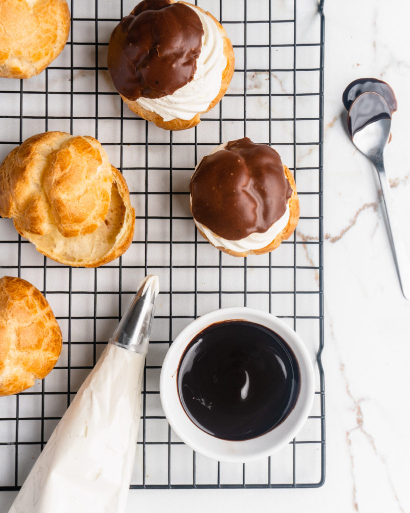 Perfectly puffed cream puffs are filled with a vanilla bean creme diplomat and topped with a chocolate glaze