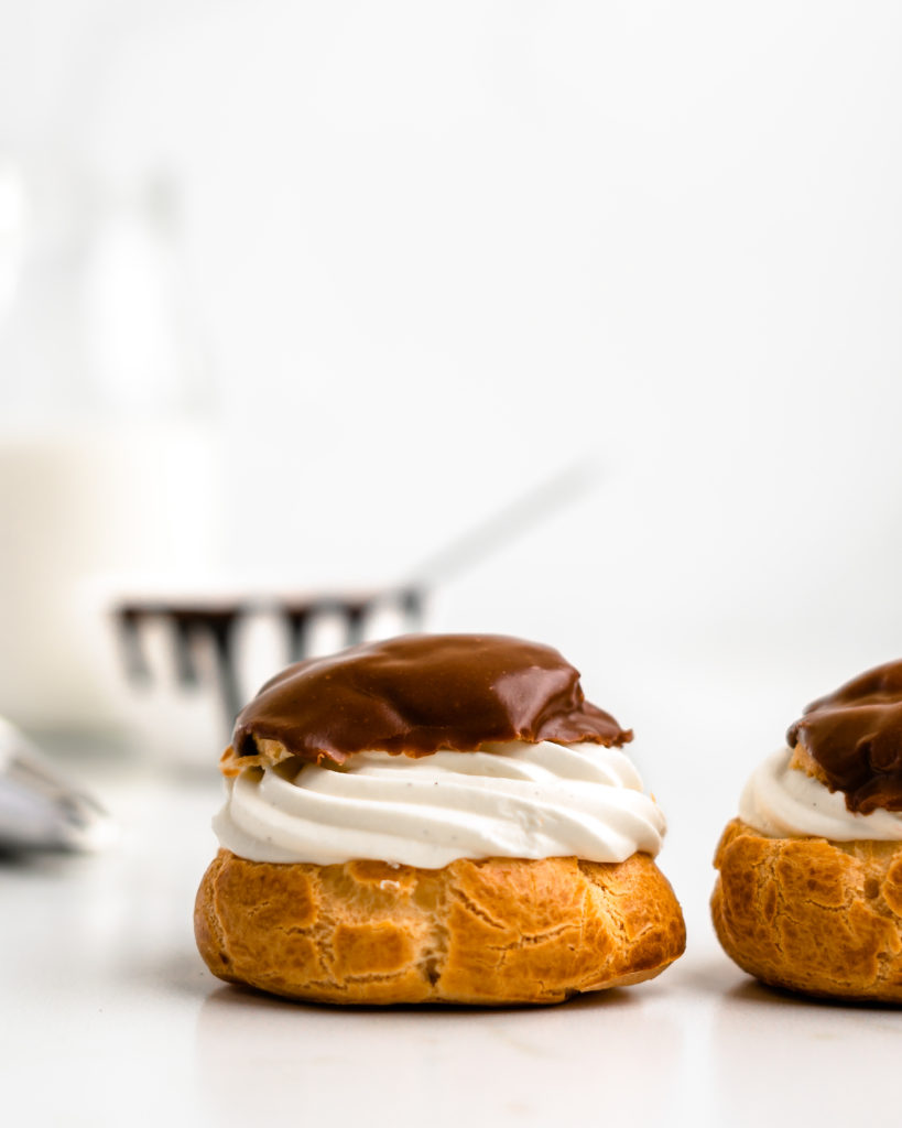 Perfectly puffed cream puffs are filled with a vanilla bean creme diplomat and topped with a chocolate glaze