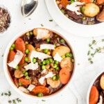 Melt in your mouth pieces of chuck steak, vibrant thick cut carrots, buttery baby potatoes, and brightly flavored peas are braised in a red wine liquid to create a delicious and hearty beef stew