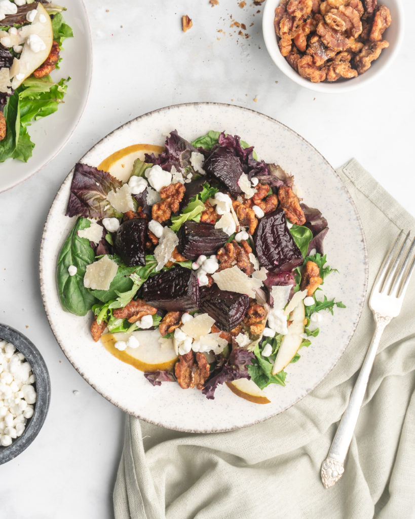 This delicious salad is made up on maple and brown sugar glazed beets, sliced crisp bosc pears, creamy tart goat cheese, shaved parmesan, and candied walnuts.