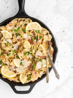Prosciutto, cream, peas, and lemon come together to form the sauce that will cover the delicious ribbons of fettuccine.