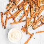 crispy oven baked yam fries are topped with finely shredded parmesan cheese and served with a flavorful homemade truffle lemon aioli