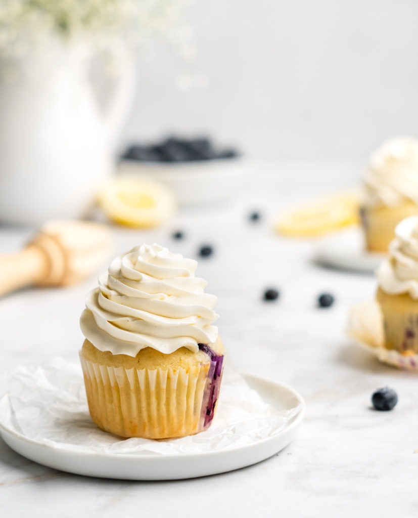 light and moist lemon cupcakes are speckled with little bursts of sweet fresh blueberries. Topped with a light and fresh lemon-infused mascarpone whipped cream