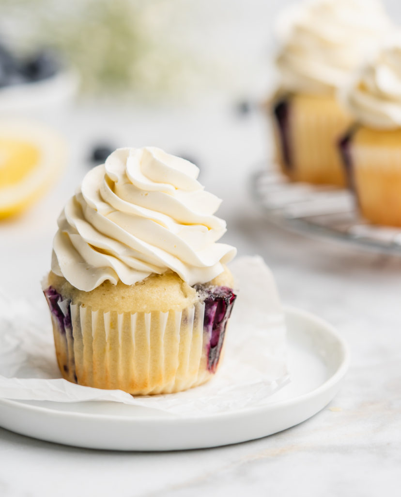 light and moist lemon cupcakes are speckled with little bursts of sweet fresh blueberries. Topped with a light and fresh lemon-infused mascarpone whipped cream