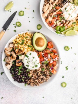 brown rice, grilled tequila lime chicken, corn, salsa, black beans, cilantro, avocado, and burrito sauce make up these amazing tequila lime grilled chicken burrito bowls