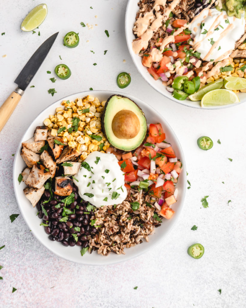 brown rice, grilled tequila lime chicken, corn, salsa, black beans, cilantro, avocado, and burrito sauce make up these amazing tequila lime grilled chicken burrito bowls