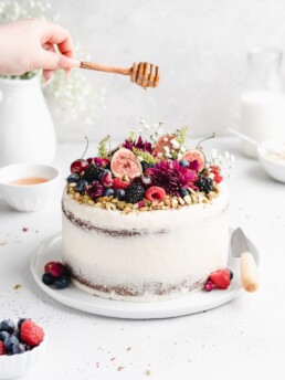This Pistachio cake is styled in a semi-naked fashion with honey rosewater swiss meringue buttercream