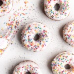 Perfectly cut donuts are made with brown butter and vanilla to amp up the flavor. Frosted with white glaze and rainbow sprinkles