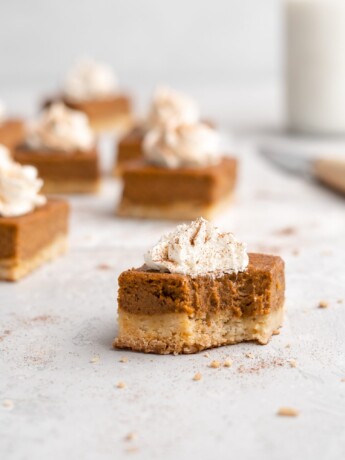 Flavorful, silky pumpkin pie is placed on top of a buttery shortbread layer, and cut into squares