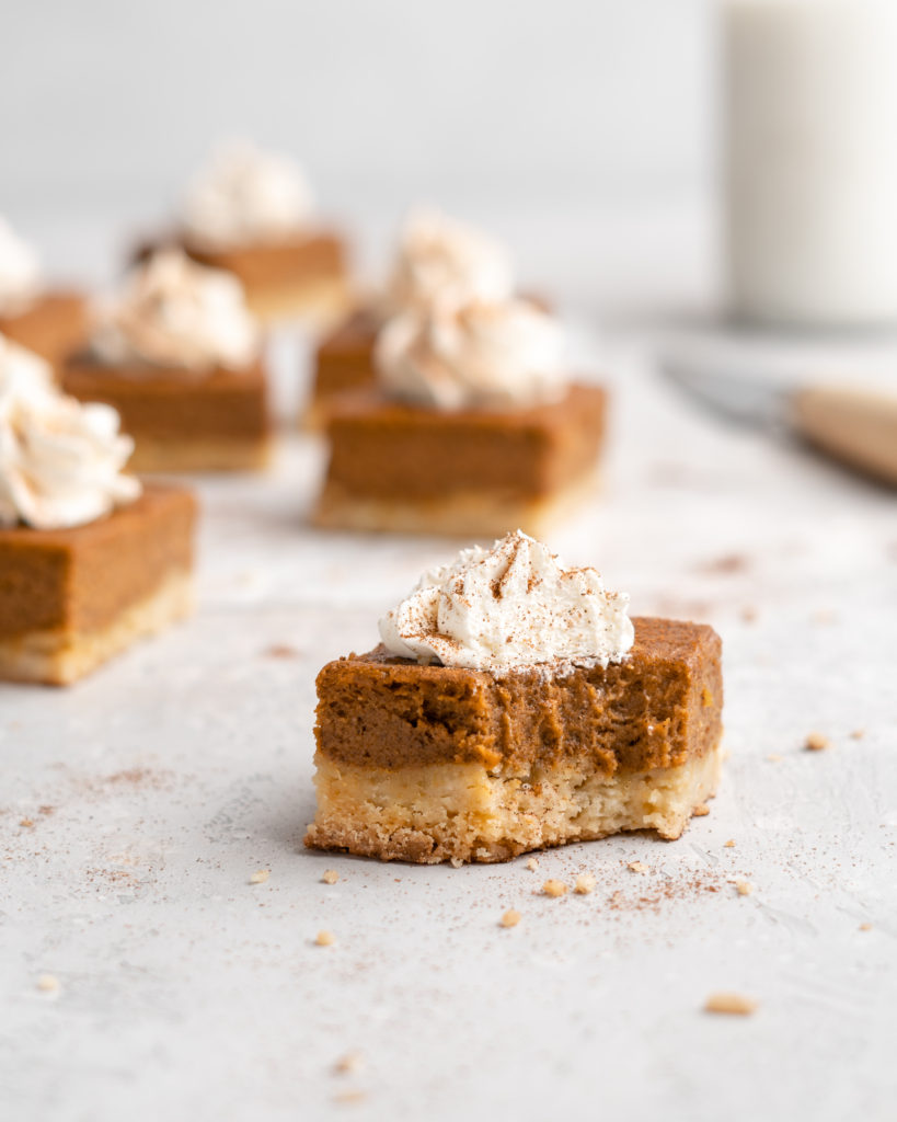 Flavorful, silky pumpkin pie is placed on top of a buttery shortbread layer, and cut into squares