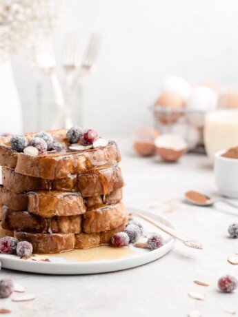 This delicious Christmas-themed French Toast is soaked in an eggnog custard and topped with a buttered maple bourbon syrup