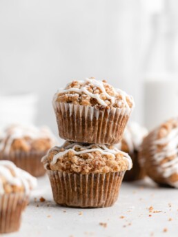 These moist banana muffins are topped with a buttery streusel topping and a simple creamy glaze!