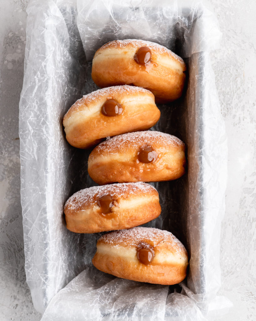 Filled with creamy, deeply sweet dulce de leche, these filled yeast donuts are crazy delicious