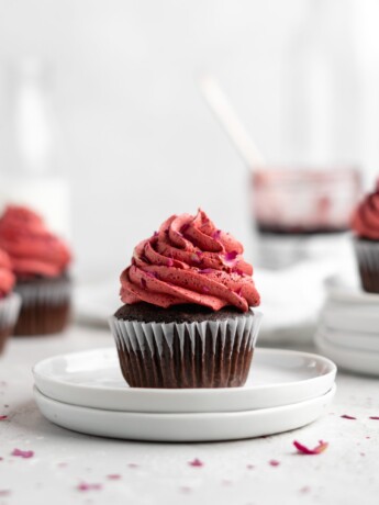 Fudgy chocolate cupcakes are filled with sweet cherry jam and topped with a cherry rosewater frosting