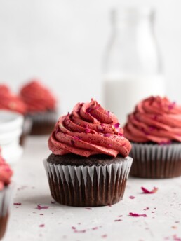 Fudgy chocolate cupcakes are filled with sweet cherry jam and topped with a cherry rosewater frosting
