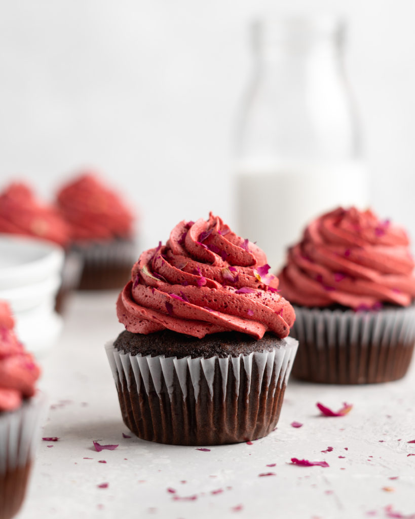 Fudgy chocolate cupcakes are filled with sweet cherry jam and topped with a cherry rosewater frosting