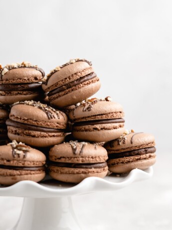 Chocolate macarons are filled with a delicious and easy to make Nutella Buttercream in these Nutella Macarons