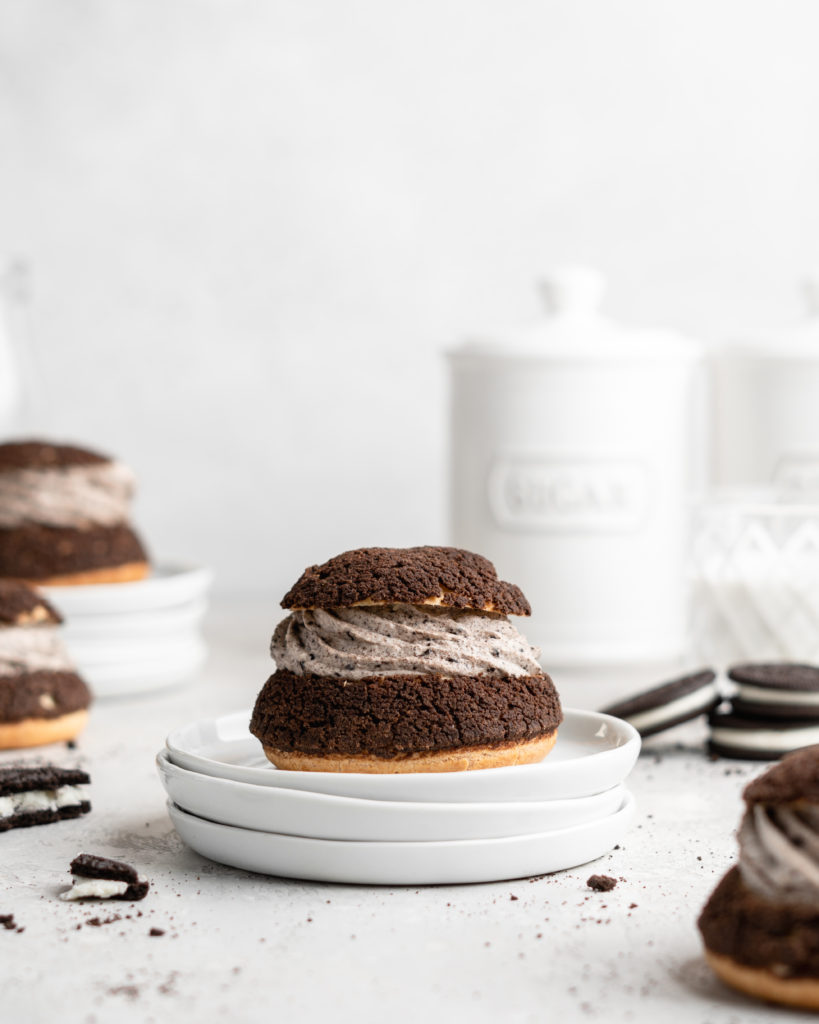 Cream Puffs topped with a chocolate craquelin, filled with an Oreo cheesecake filling