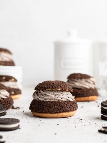 Cream Puffs topped with a chocolate craquelin, filled with an Oreo cheesecake filling