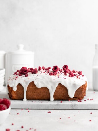 Loaf cake that is flavoured with rosewater and speckled with fresh raspberries. Glazed with a thick rosewater glaze