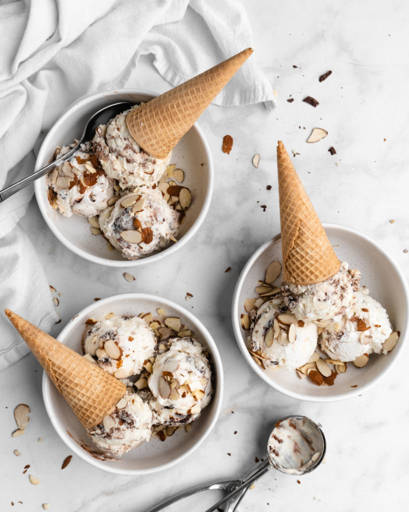 No churn almond ice cream is infused with a mocha swirl and full of chopped almonds, scooped into bowls