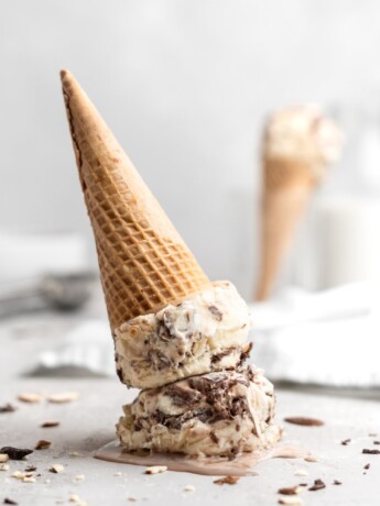 No churn almond ice cream is infused with a mocha swirl and full of chopped almonds, scooped into a cone