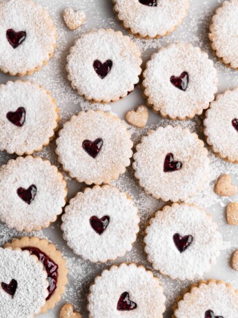 Linzer Cookies dusted with confectioners sugar and filled with raspberry jam