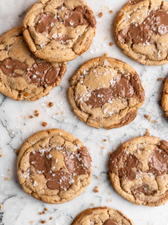 Chewy golden Toffee Milk Chocolate Chip Cookies on marble counter