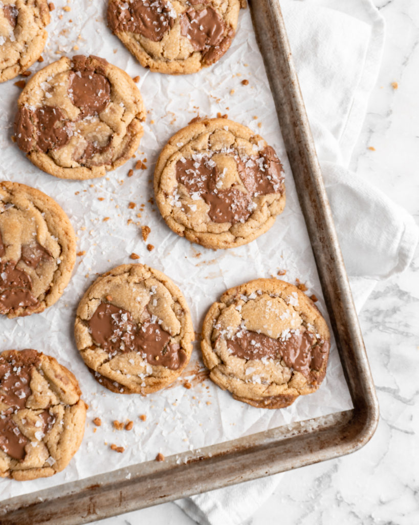 Chewy golden Toffee Milk Chocolate Chip Cookies on baking sheet