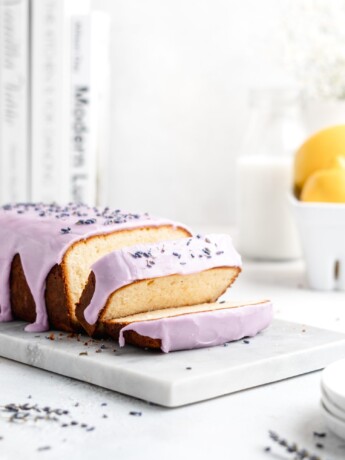 Fluffy and moist Lemon and lavender loaf cake is glazed in a purple coloured vanilla glaze