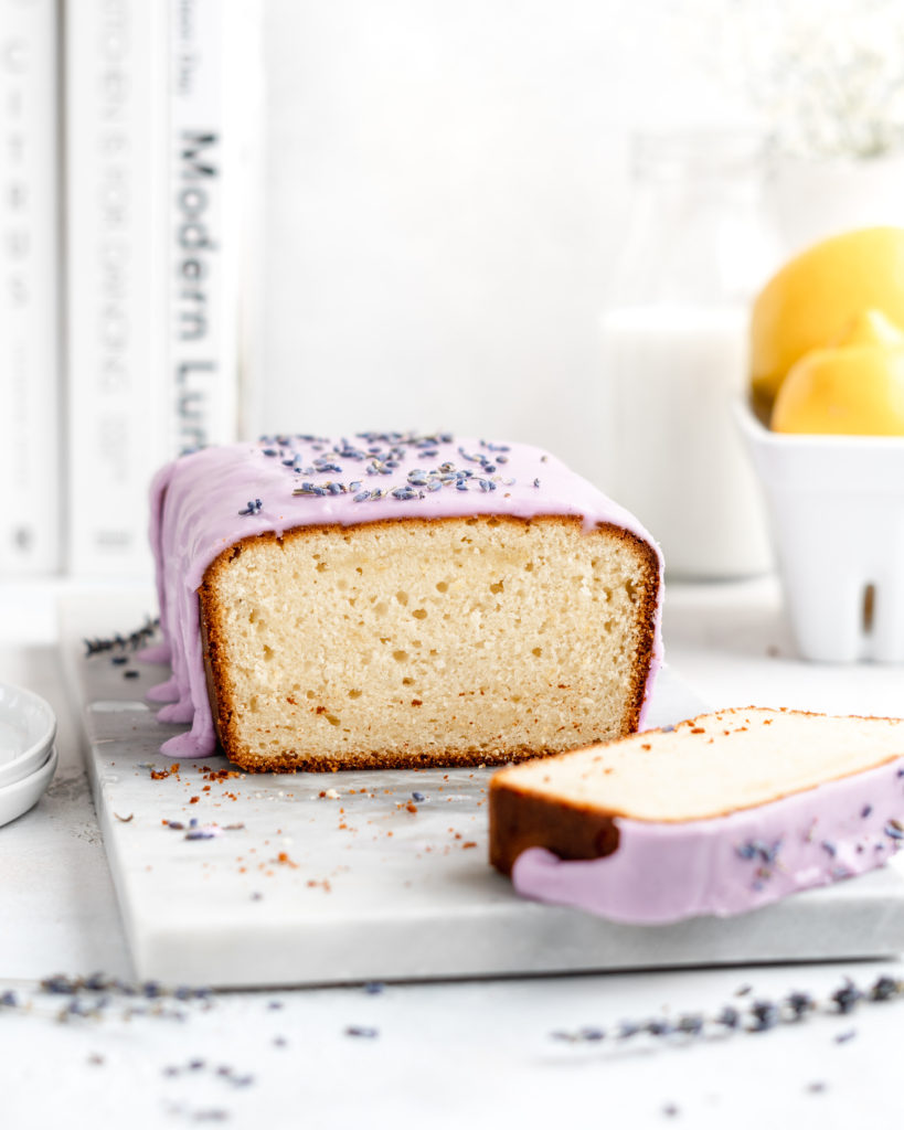 Fluffy and moist Lemon and lavender loaf cake is glazed in a purple coloured vanilla glaze