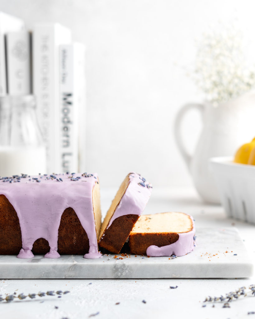 Fluffy and moist Lemon and lavender loaf cake is glazed in a purple coloured vanilla glaze