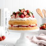 Light and fluffy sponge cake layers are sandwiched over a layer of mascarpone whipped cream and macerated strawberries in this Strawberry Shortcake Layer Cake